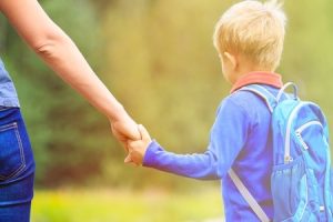 child support-mother holding hand of little son